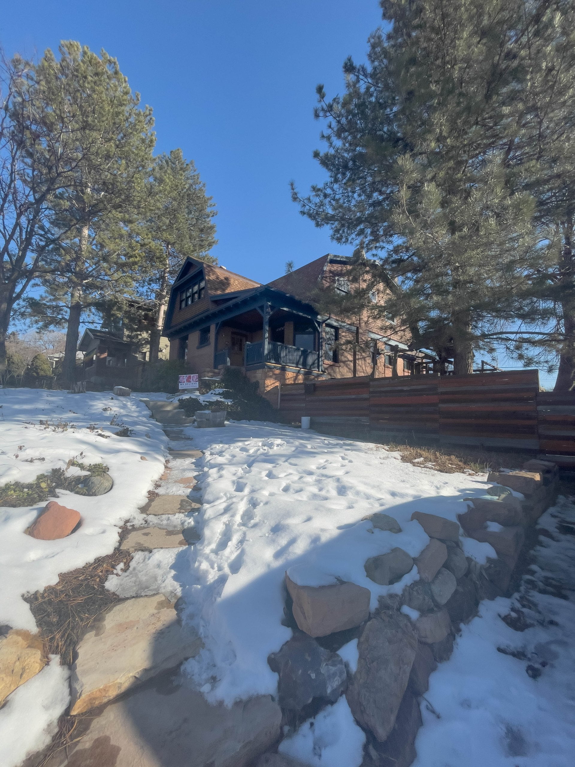 Exterior of historic home remodel with snow in the yard.