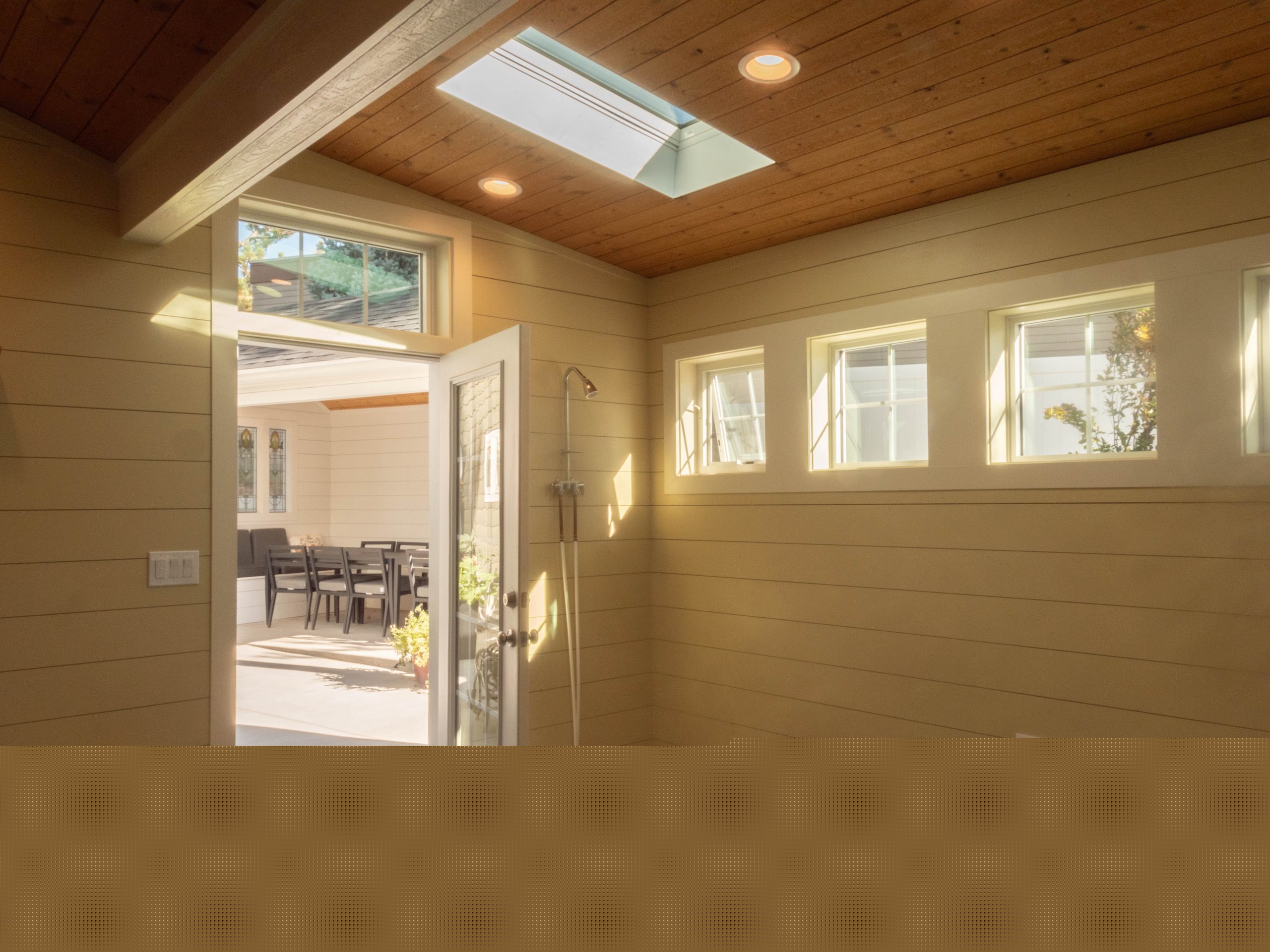 Shower for the pool by the door and with a skylight above.