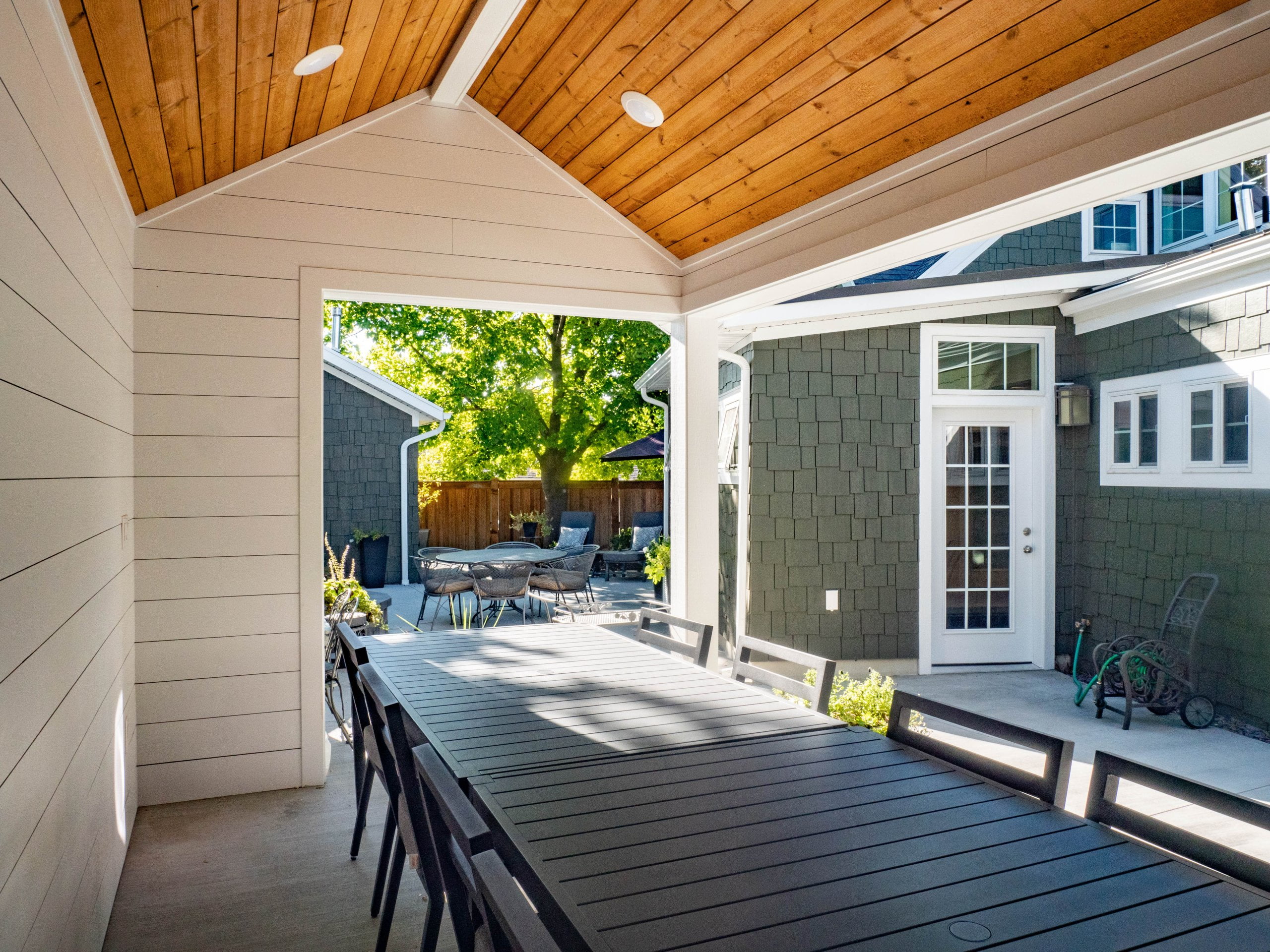 Covered patio with table and chairs.