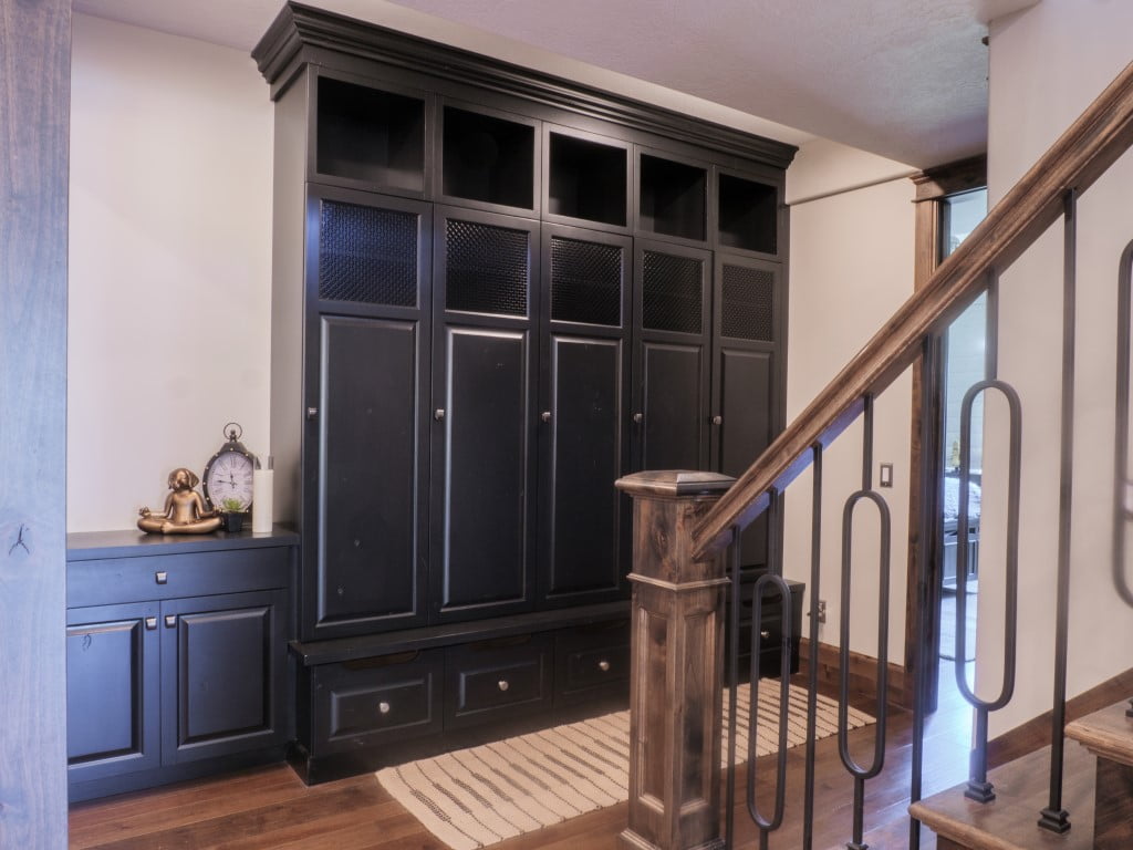 Built-in cabinets in the hallway at the bottom of the staircase.