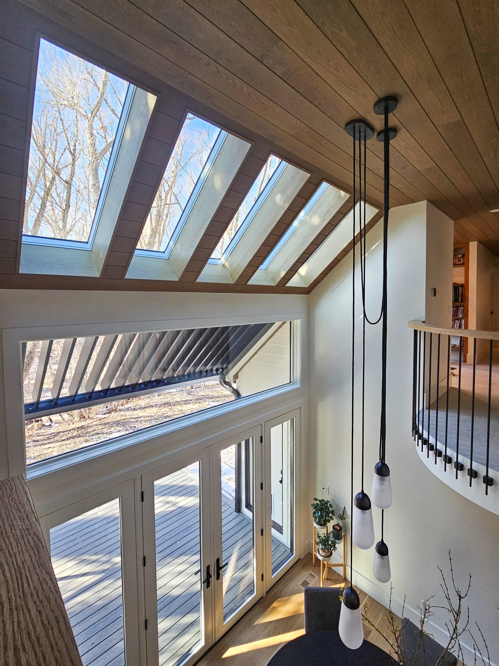 Balcony overlooking the dining room with large windows and five skylights.