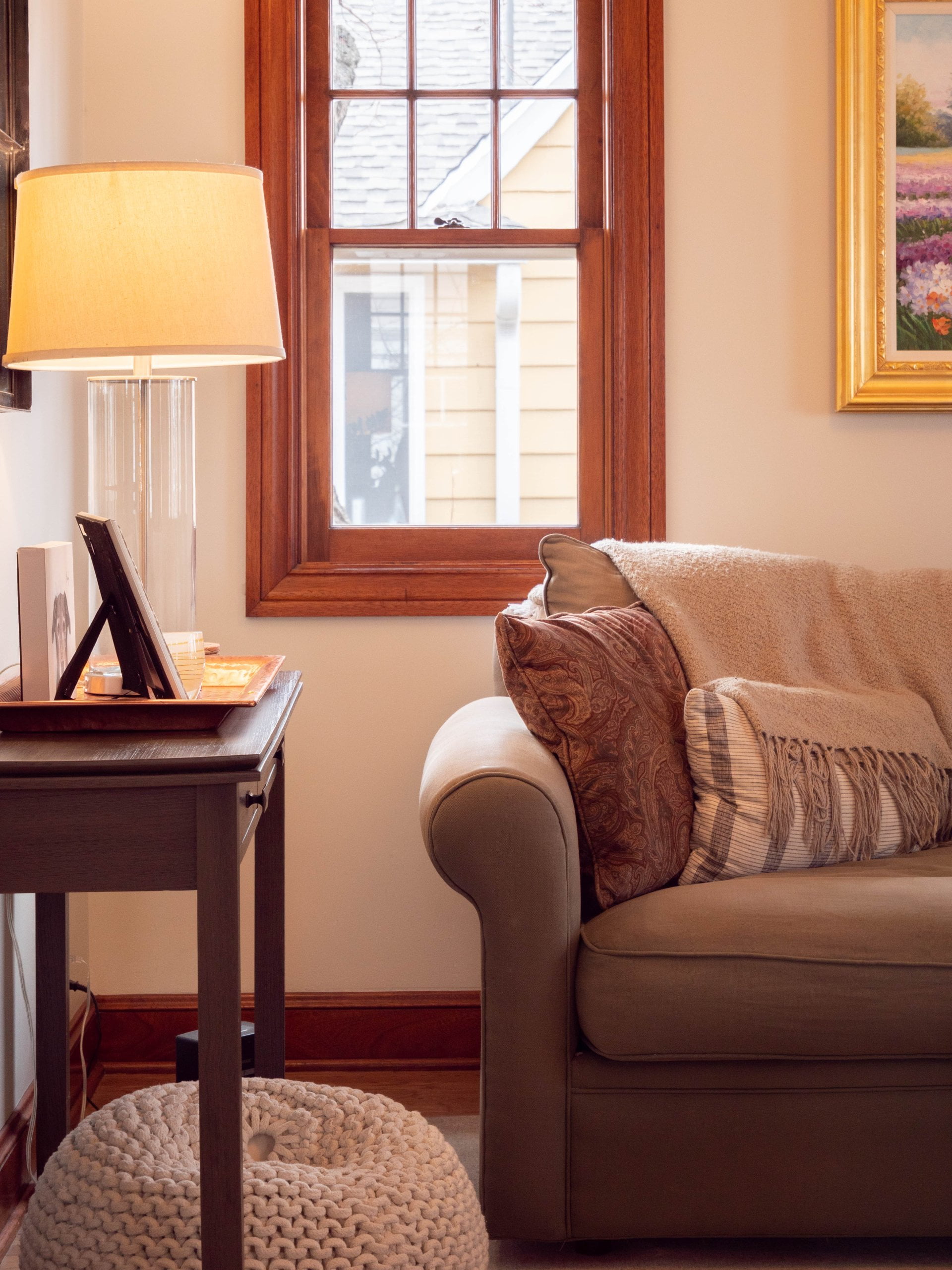 Living room with a couch under the window.