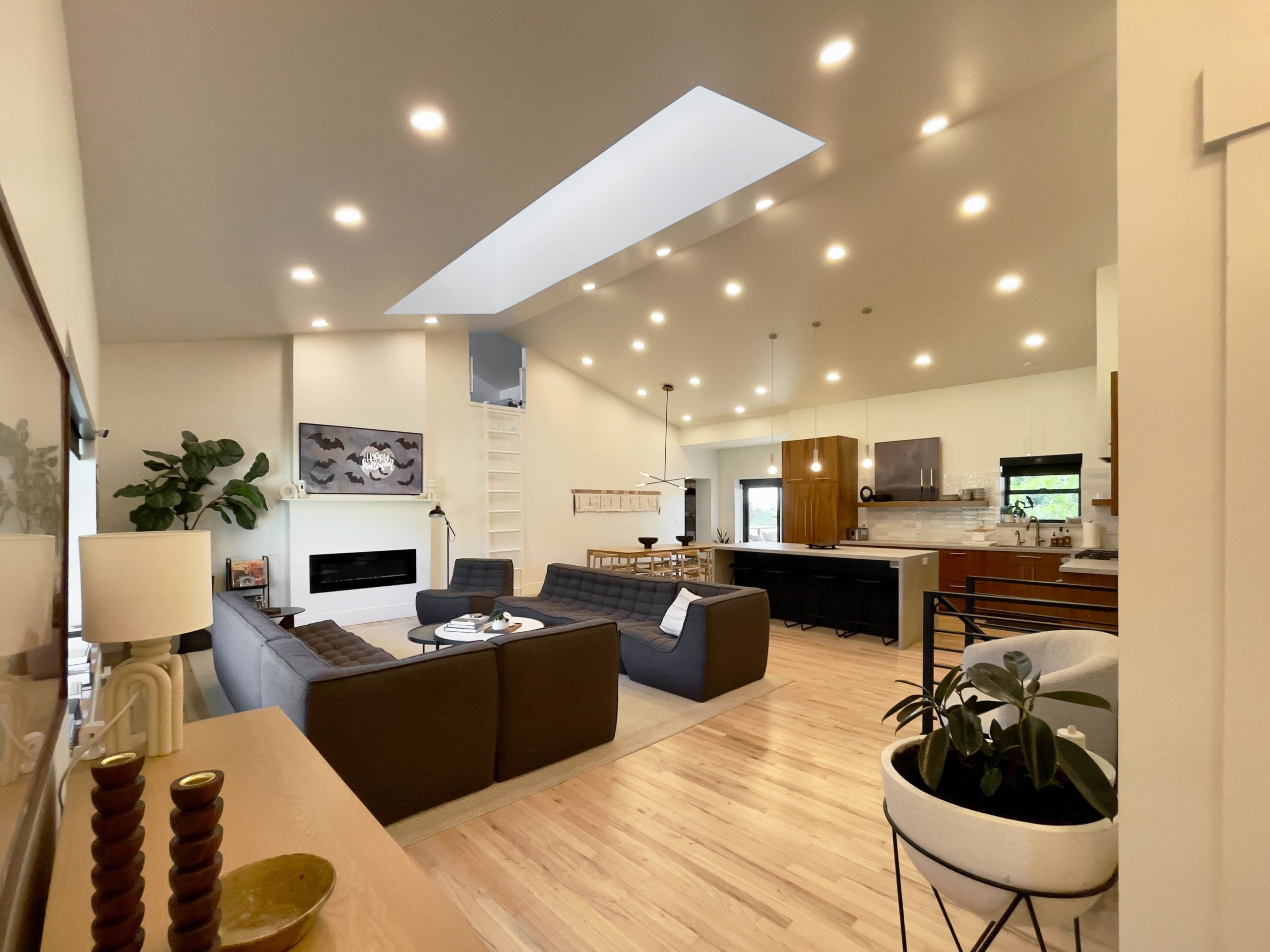 Large great room with vaulted ceilings and an open concept living room, dining room, and kitchen.