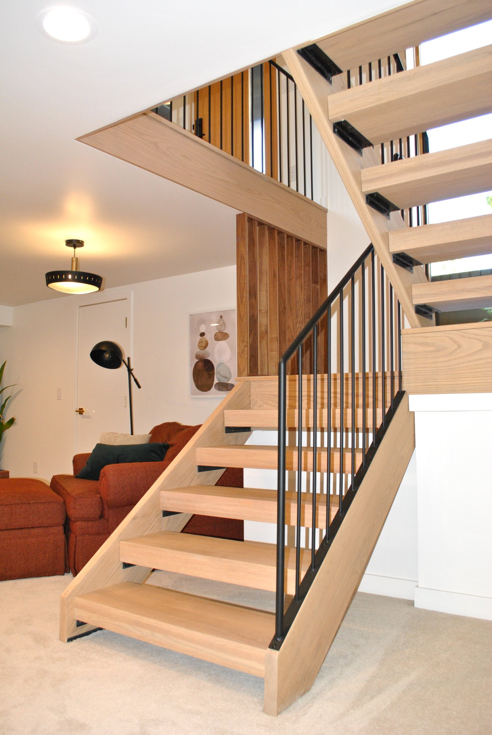 Mid-century modern stairs with open risers and wood treads.