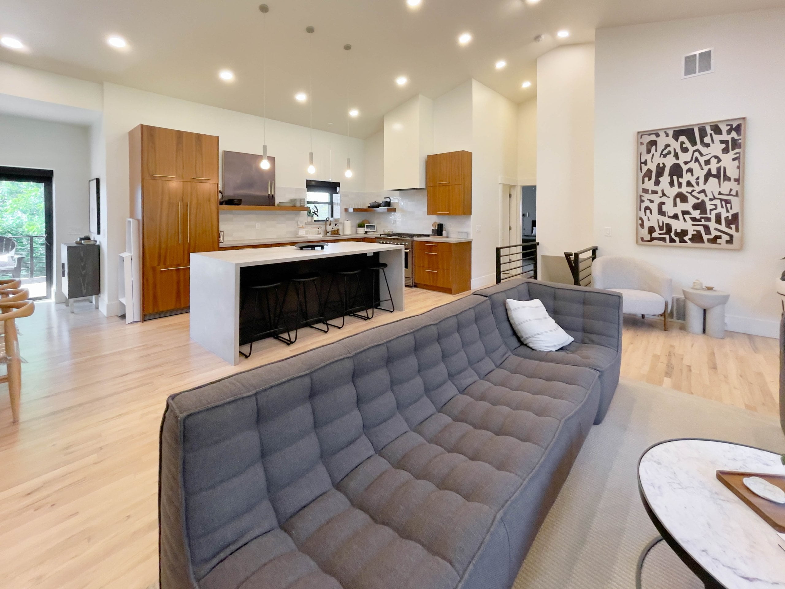 Open concept great room looking from the living room couch to the kitchen.