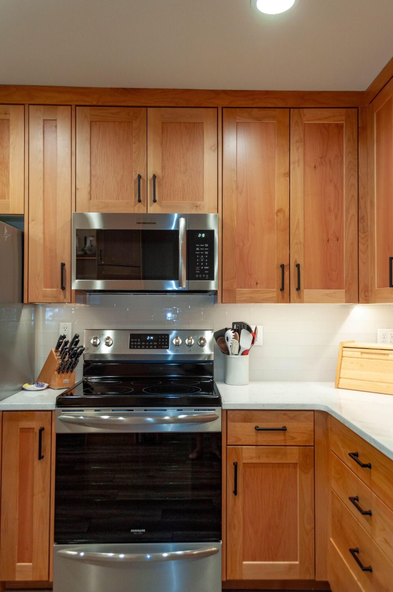 Kitchen stove and oven with microwave installed above.