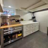 Thumbnail of http://Custom%20basement%20workshop%20with%20a%20tool%20bench,%20storage,%20and%20a%20window.