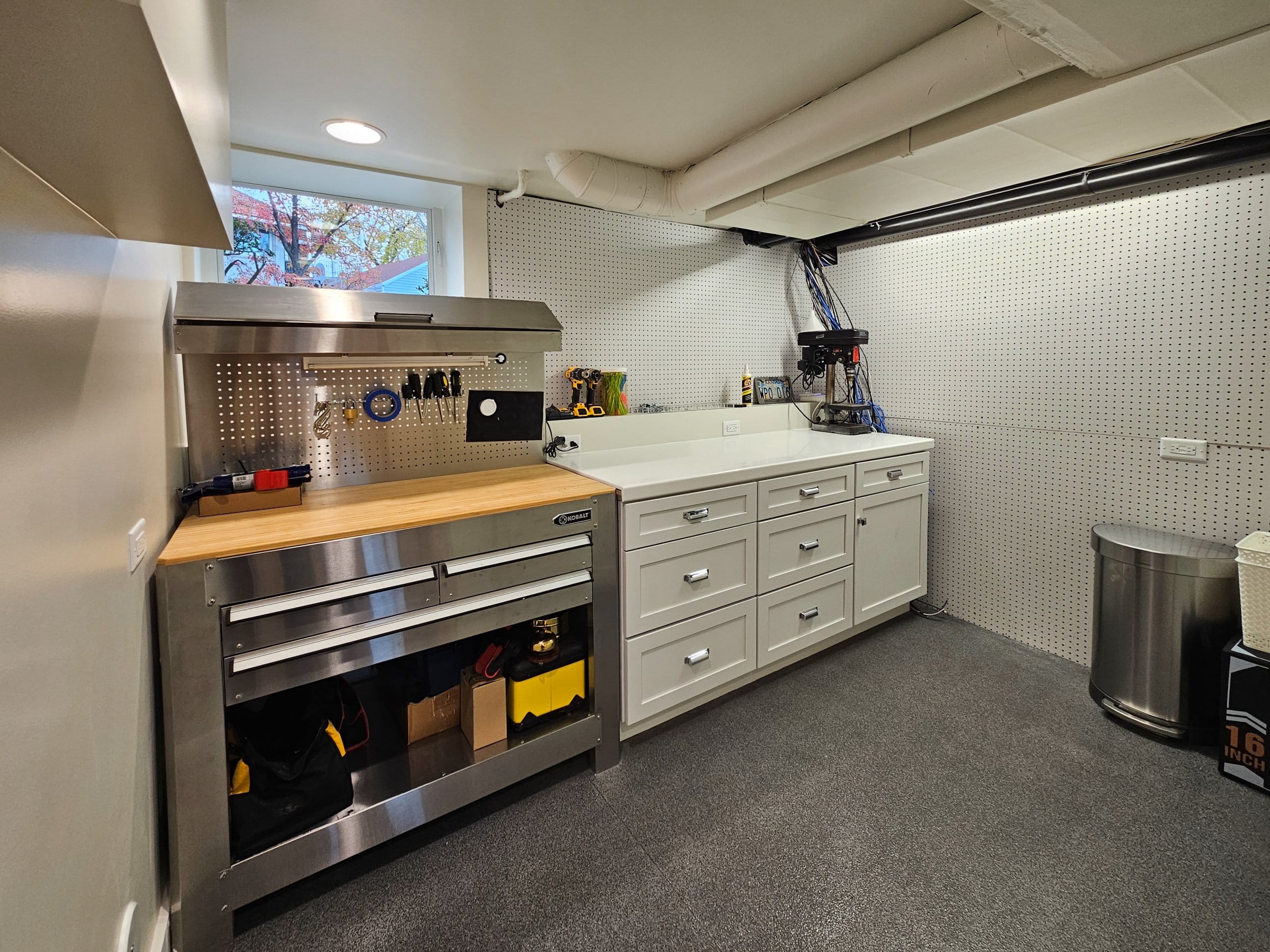 Custom basement workshop with a tool bench, storage, and a window.