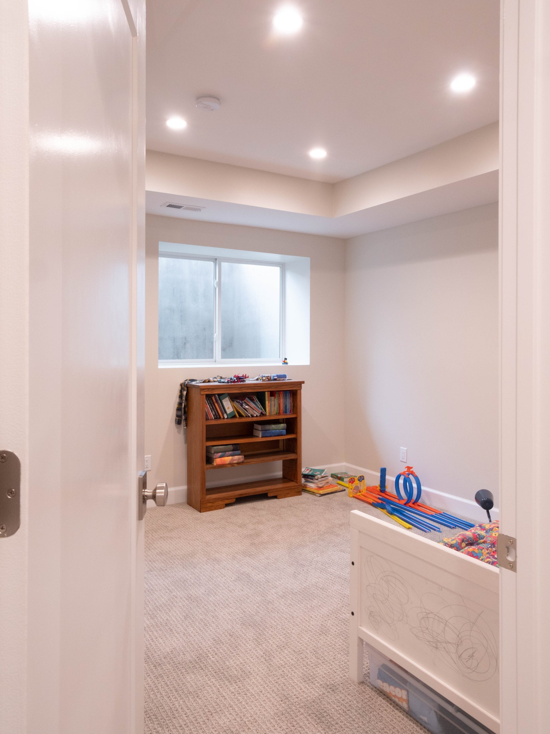Basement bedroom after the remodel with an egress window.