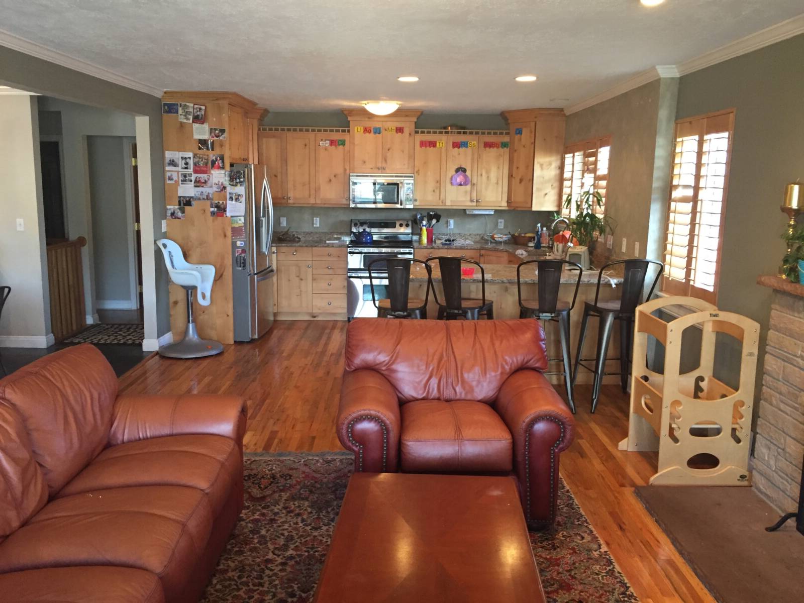 The small and dated kitchen before the remodel with an open concept layout to the family room.