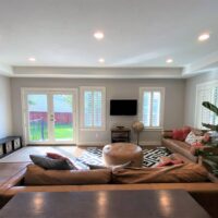 Thumbnail of http://Open%20concept%20living%20room%20with%20furniture%20and%20doors%20to%20the%20backyard.