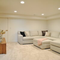 Thumbnail of http://Basement%20family%20room%20with%20a%20large%20couch%20looking%20toward%20the%20wall%20with%20the%20TV.