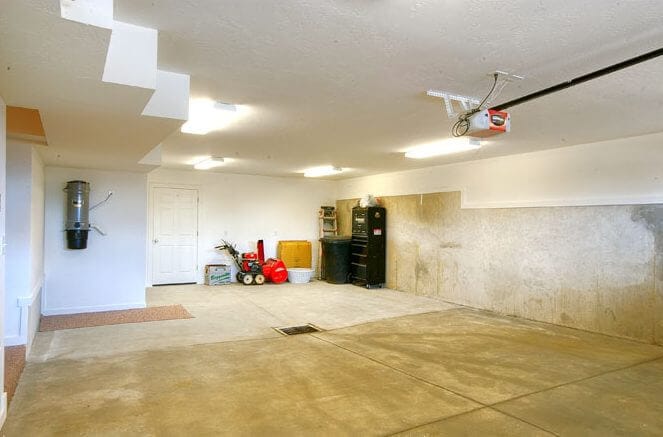 large garage with storage space and drain | Renovation Design Group