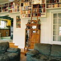 Thumbnail of http://Living%20room%20Library%20with%20transition%20steps%20from%20kitchen%20|%20Renovation%20Design%20Group