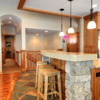 Thumbnail of http://fter_Interior_Great%20Room%20Designs_1980's%20Home%20Update_stone%20in%20the%20kitchen_Tile%20and%20wood%20flooring%20together_pendulum%20lights_Kitchen%20island%20bar_Bar%20stools_Window%20Seats%20|%20Renovation%20Design%20Group