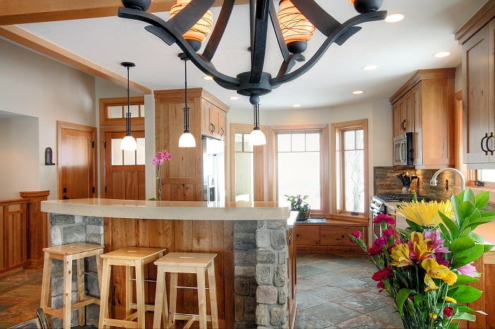 fter_Interior_Great Room Designs_1980's Home Update_stone in the kitchen_Tile and wood flooring together_pendulum lights_Kitchen island bar_Bar stools_Window Seats | Renovation Design Group