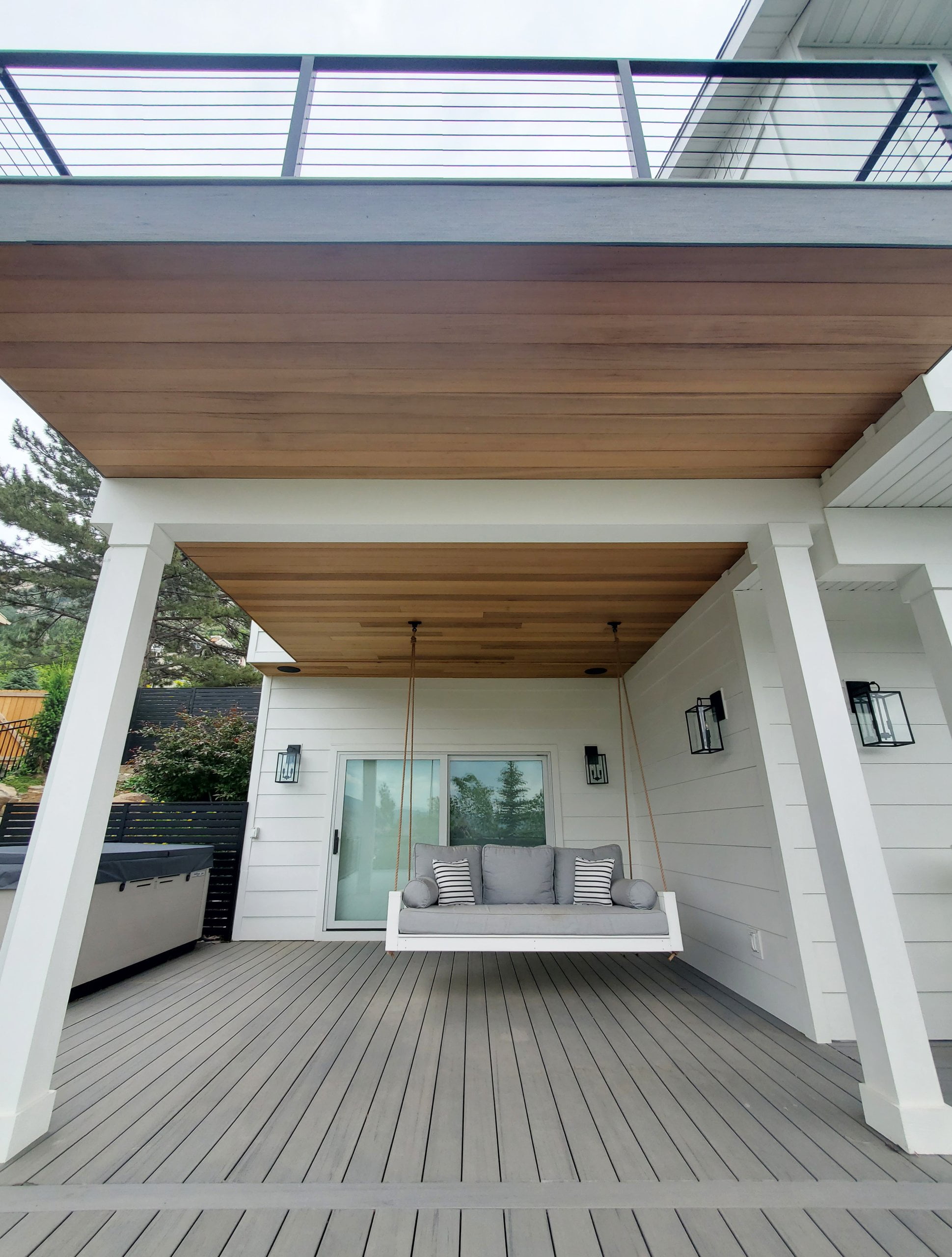 Deck with a deck above and porch swing.