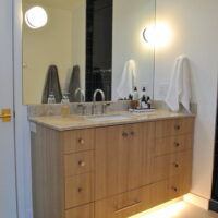 Thumbnail of http://Bathroom%20vanity%20sink%20with%20light%20underneath%20and%20on%20the%20sides%20of%20the%20mirror.