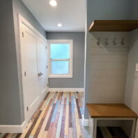 Thumbnail of http://Mudroom%20with%20painted%20wood%20floors,%20a%20large%20closet,%20and%20a%20built-in%20cabinet.