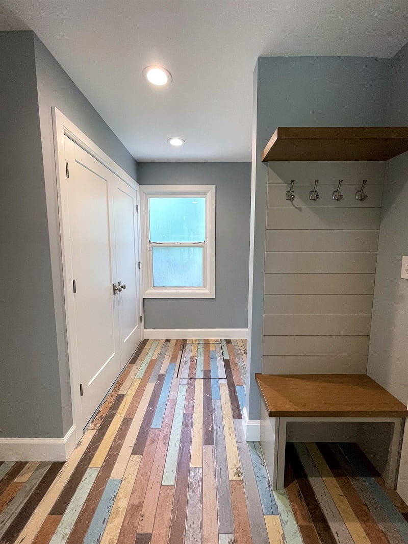 Mudroom with painted wood floors, a large closet, and a built-in cabinet.
