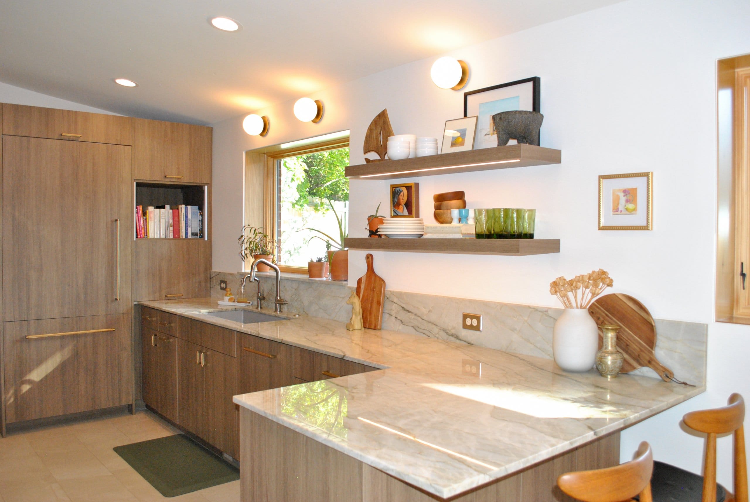 Mid-century modern kitchen with a peninsula that has room for two chairs and open shelving.
