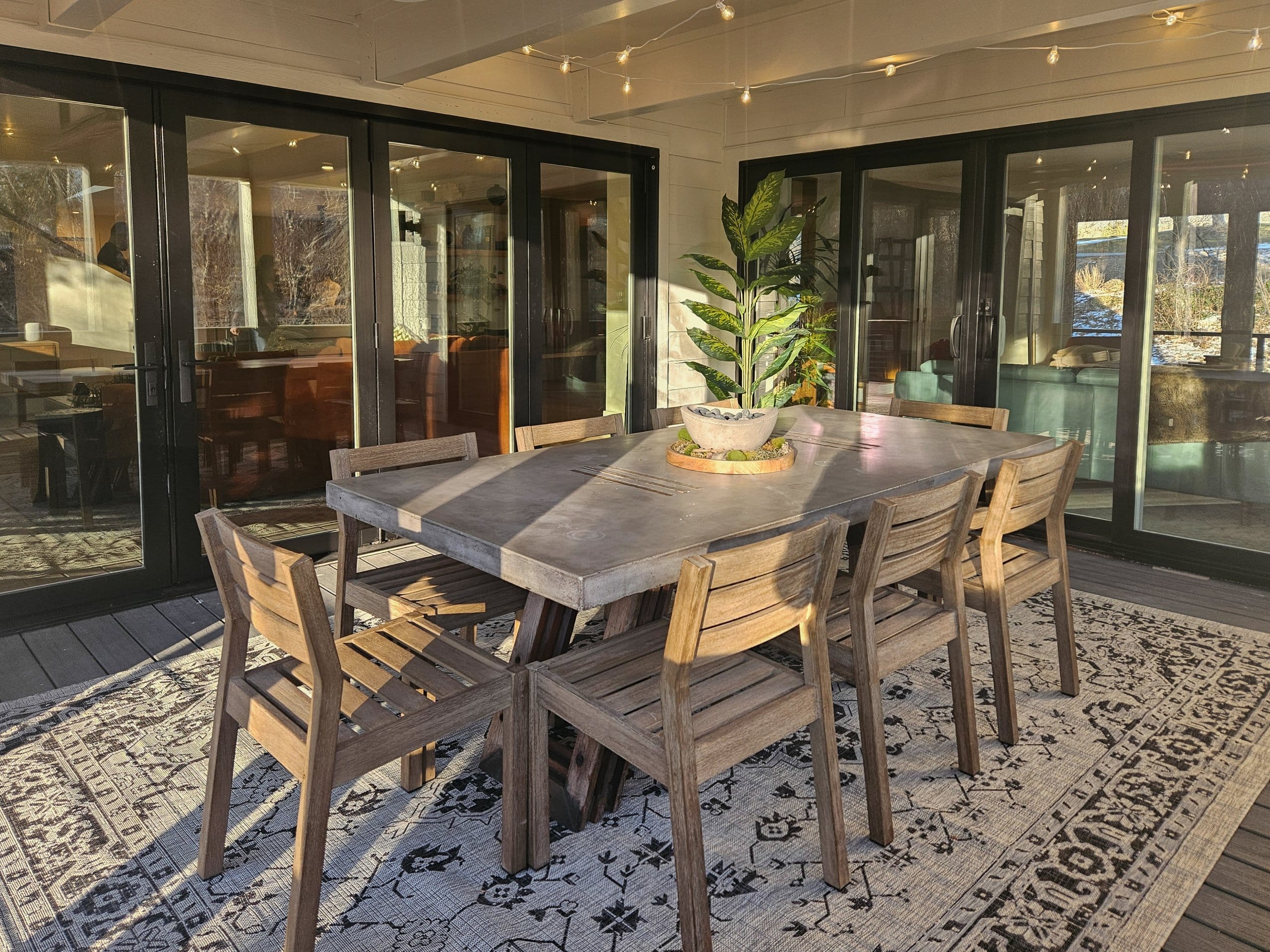 Covered patio with table and eight chairs.