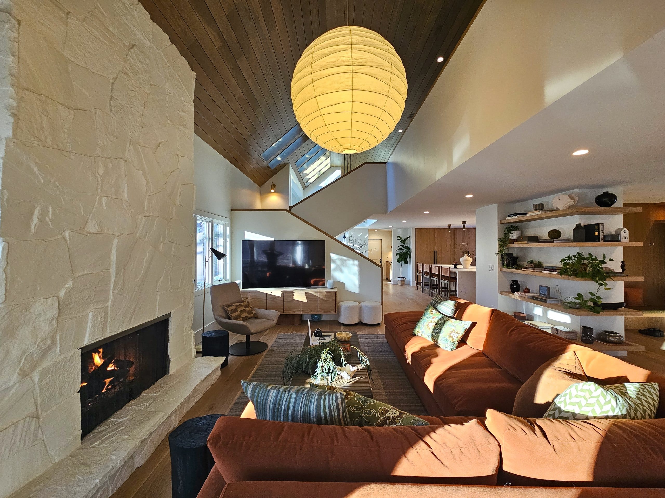 Living room with view toward the stairs and kitchen.