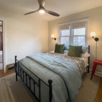 Thumbnail of http://Guest%20bedroom%20with%20a%20large%20bed%20centered%20under%20the%20window.