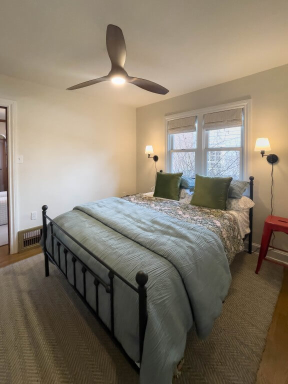 Guest bedroom with a large bed centered under the window.