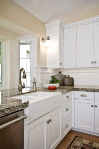White farm sink and white cabinets in kitchen | Renovation Design Group