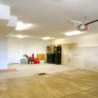 large garage with storage space and drain | Renovation Design Group