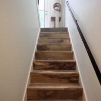 Thumbnail of http://Staircase%20with%20a%20railing%20and%20a%20cat%20tree%20at%20the%20top%20next%20to%20the%20door.