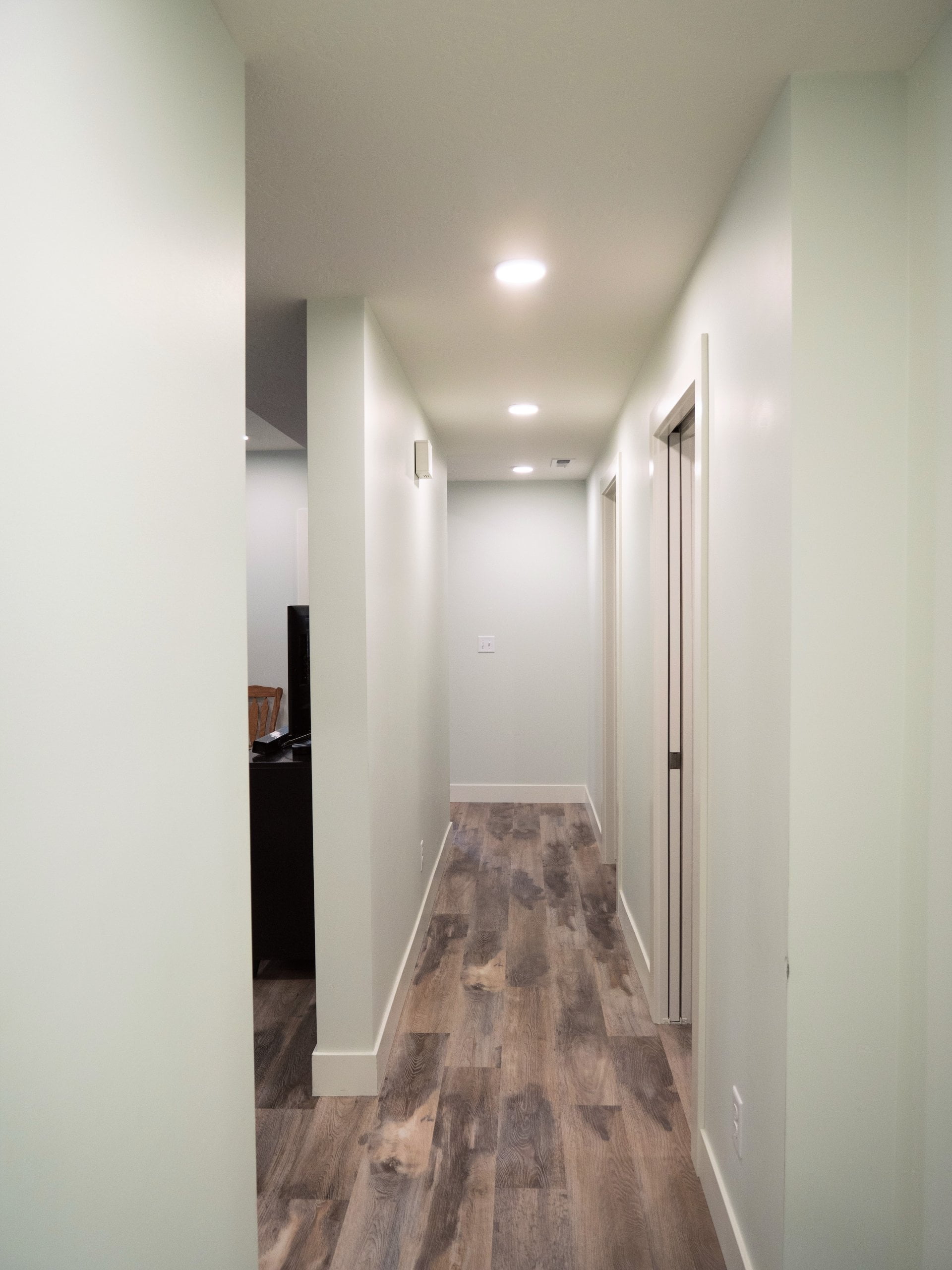 Basement hallway with white walls.