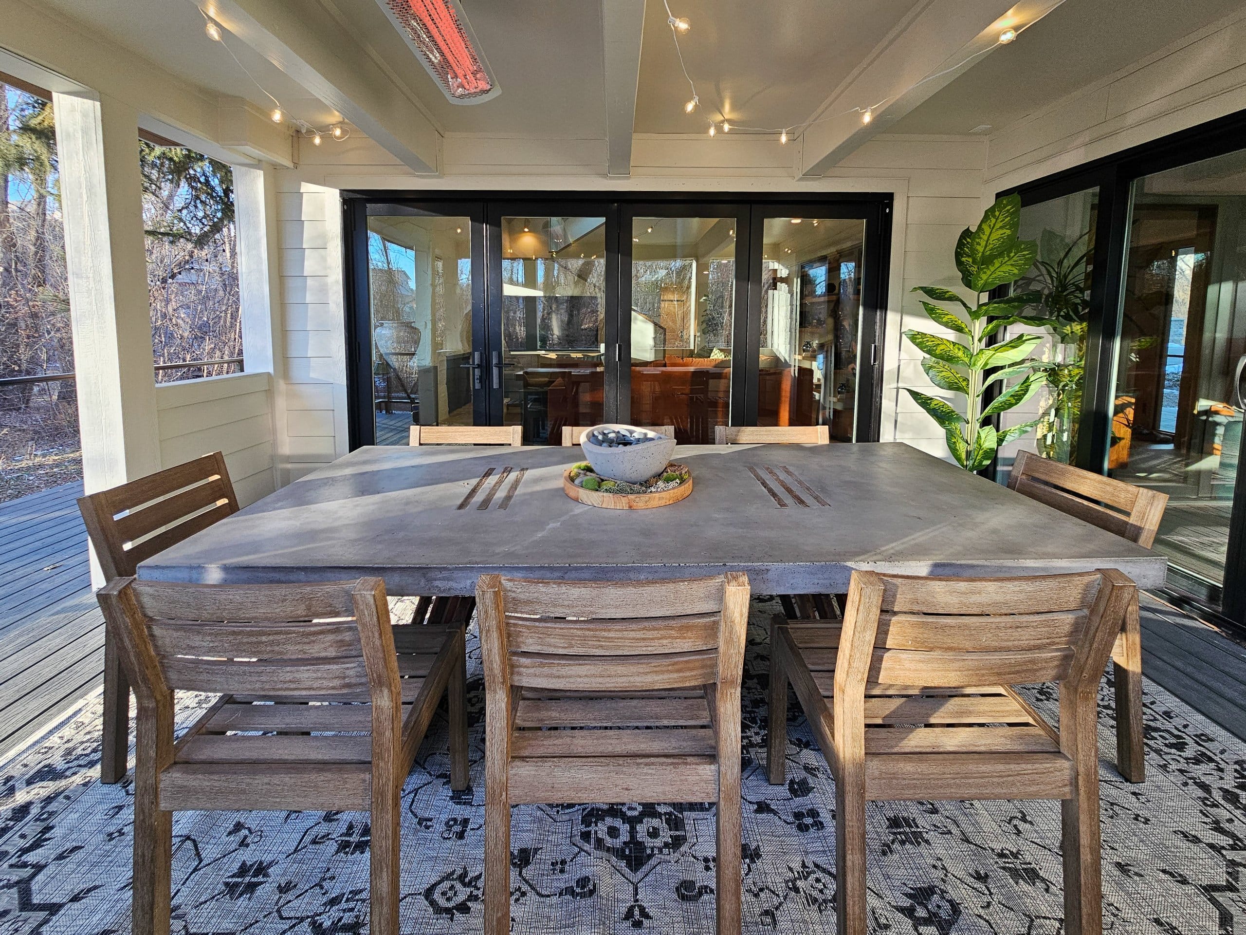 Covered patio with table and eight chairs.