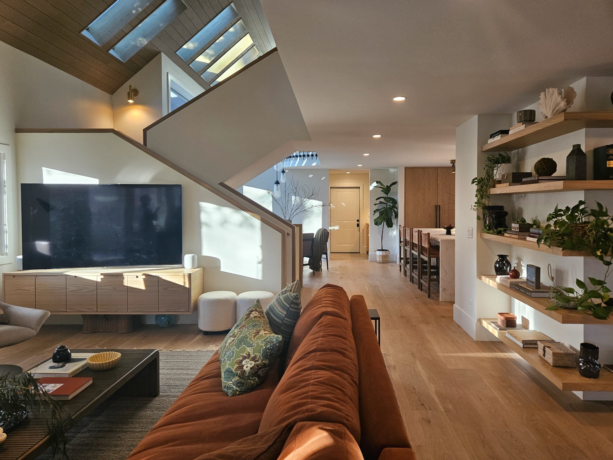 Living room with view toward the stairs and kitchen.