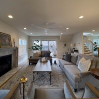 Thumbnail of http://Large%20family%20room%20addition.%20On%20the%20left%20is%20a%20modern%20fireplace,%20straight%20ahead%20past%20the%20furniture%20are%20doors%20to%20the%20backyard,%20and%20on%20the%20right%20is%20a%20staircase%20and%20the%20mudroom.