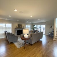 Thumbnail of http://Large%20family%20room%20addition%20with%20furniture,%20windows,%20and%20a%20modern%20fireplace.%20On%20the%20right%20is%20the%20staircase%20and%20doors%20to%20the%20backyard.