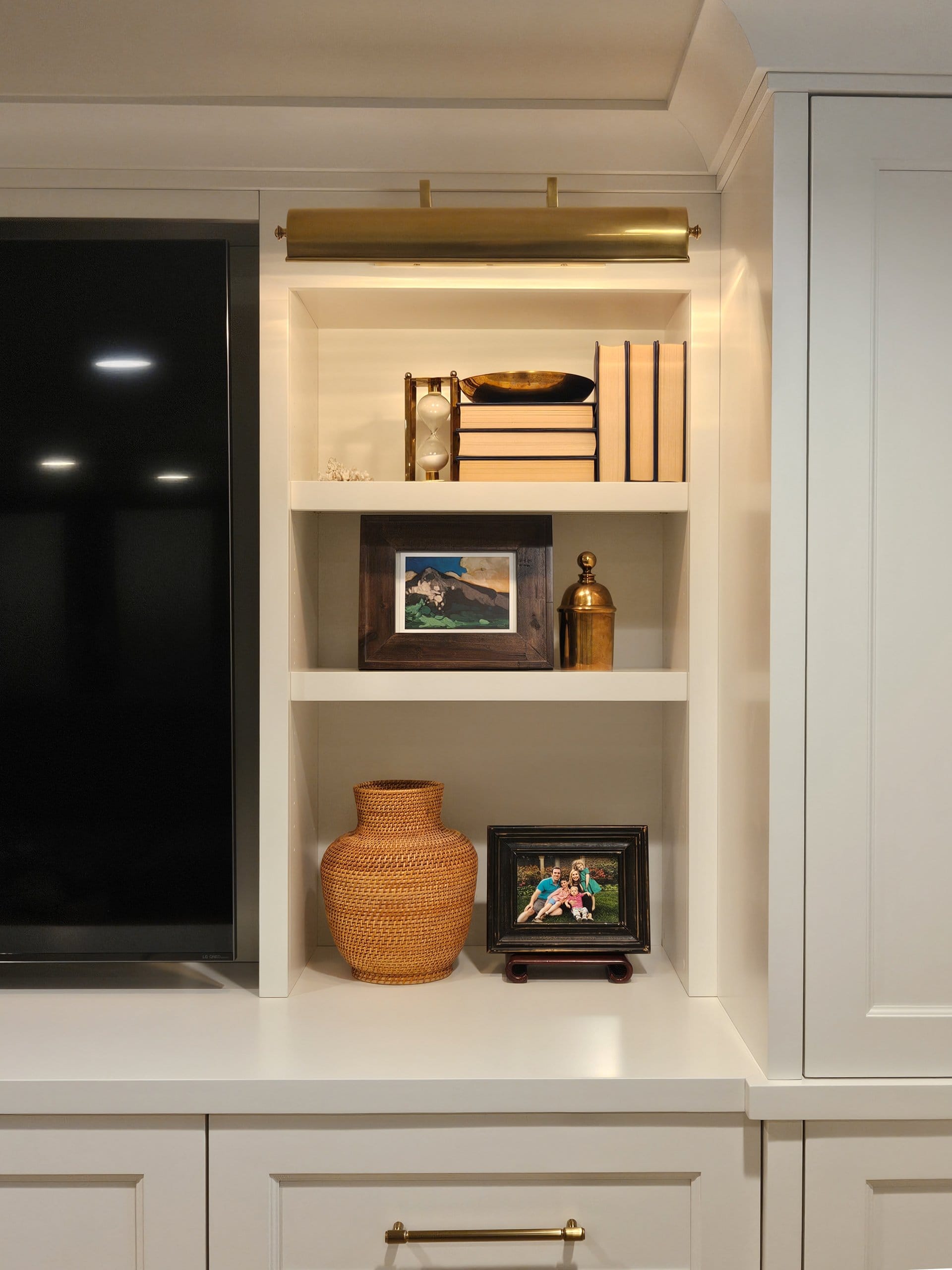 Custom built-in shelves with books, decorations, and framed photos.