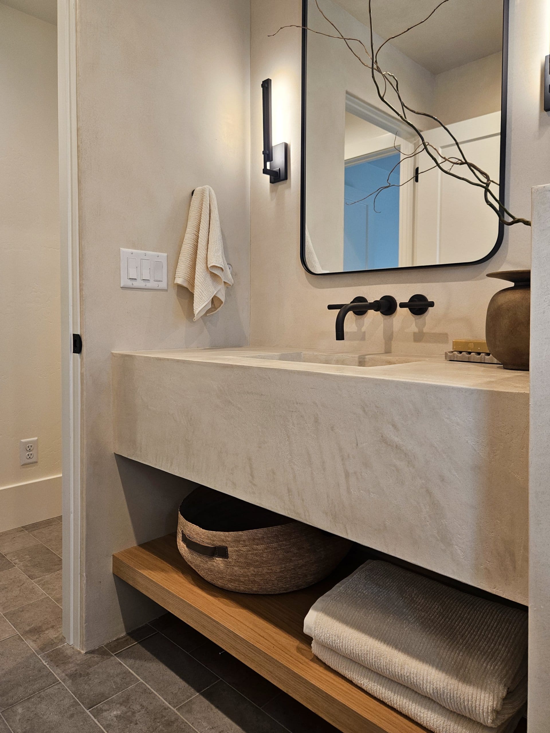 Bathroom sink with open storage underneath.