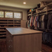 Thumbnail of http://Large%20walk-in%20closet%20with%20an%20island%20in%20the%20center,%20shoe%20storage,%20and%20hanging%20space%20for%20shirts%20and%20pants.