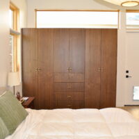 Thumbnail of http://Primary%20bedroom%20with%20built-ins%20for%20the%20closet%20and%20a%20door%20with%20a%20dog%20door%20to%20the%20side.