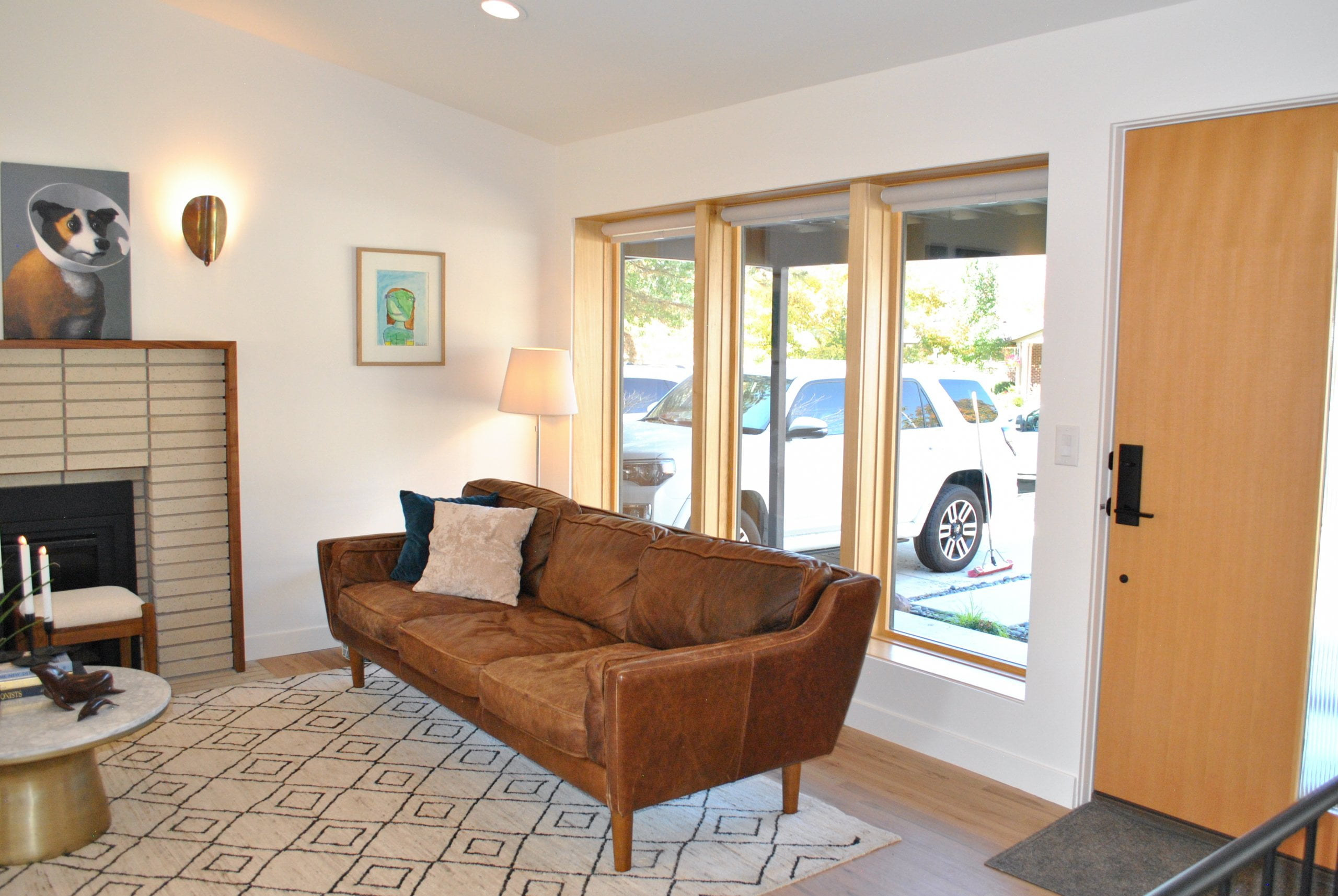 Couch centered under the windows and next to the front door.