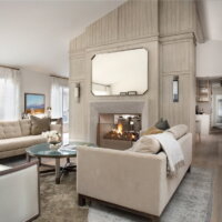 Thumbnail of http://Large%20fireplace%20in%20the%20living%20room%20with%20openings%20on%20either%20side.%20The%20room%20is%20furnished%20with%20two%20couches,%20chairs,%20a%20rug,%20and%20a%20coffee%20table.
