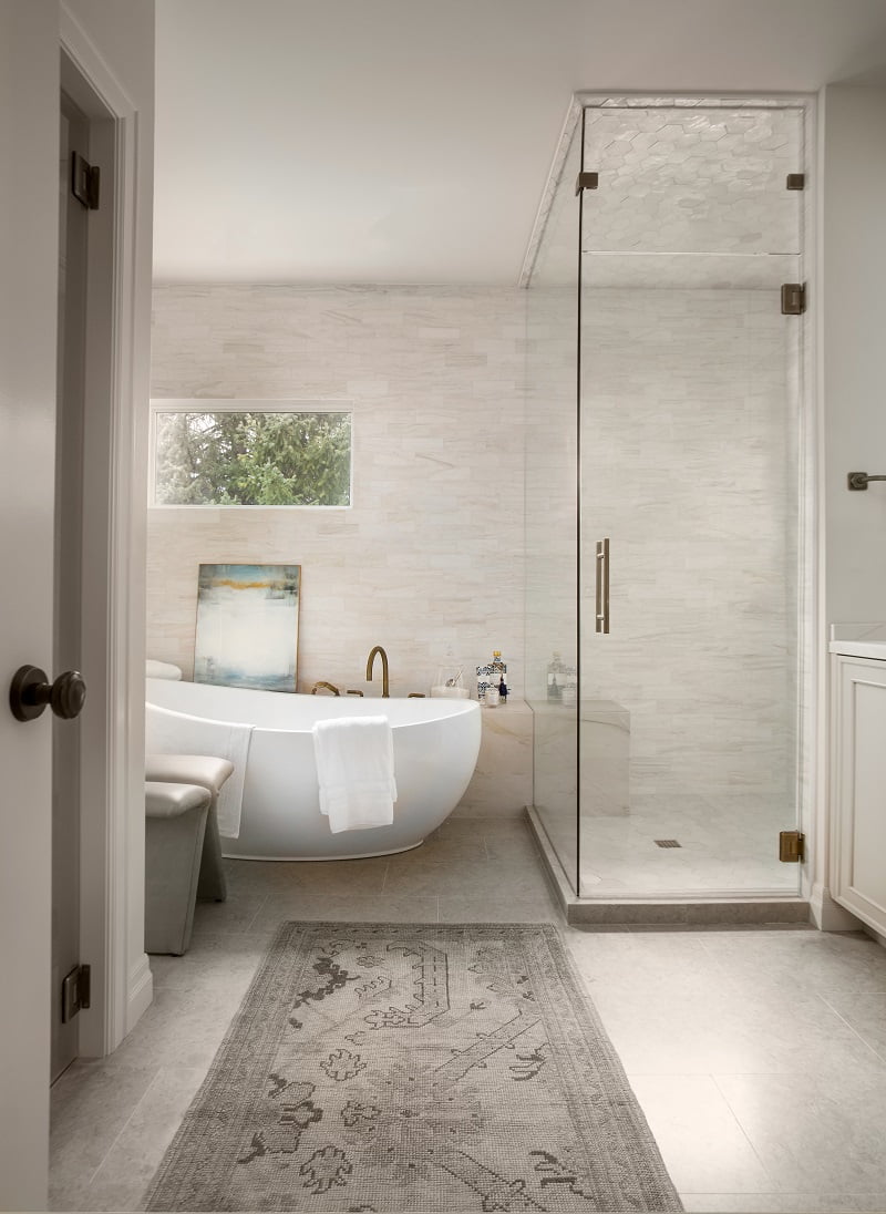 Renovated primary bathroom with a large freestanding tub and shower.
