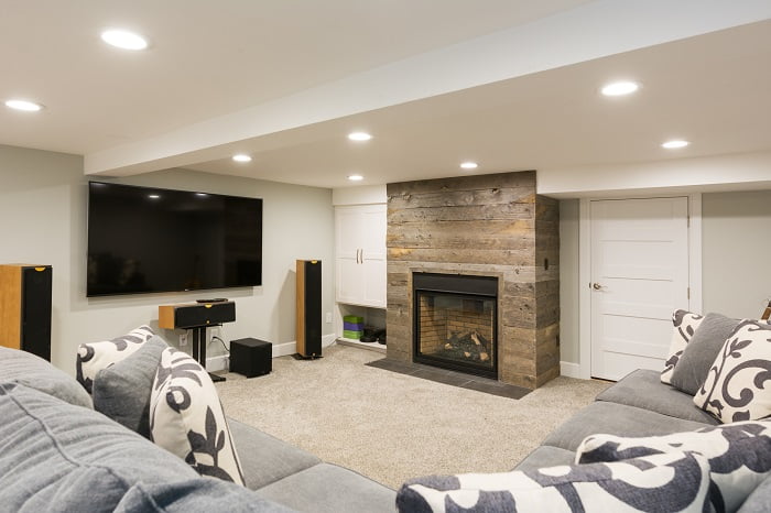 After_Interior_Basement Family Room_Bungalowwood plank fireplace | Renovation Design Group