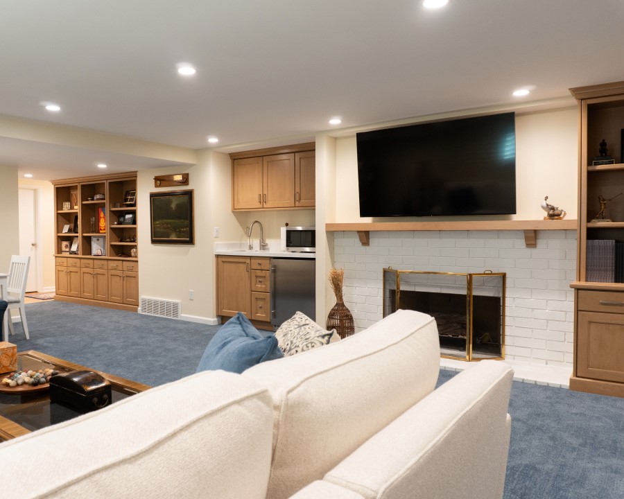 Large family room with a fireplace, built-in cabinets, and blue carpet