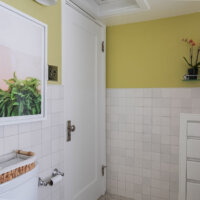 Thumbnail of http://Door%20to%20the%20bathroom%20with%20a%20picture%20hung%20on%20the%20wall%20to%20the%20side.
