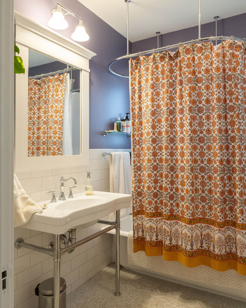 Renovated bathroom with a sink and tub. The tub is blocked by a shower curtain.