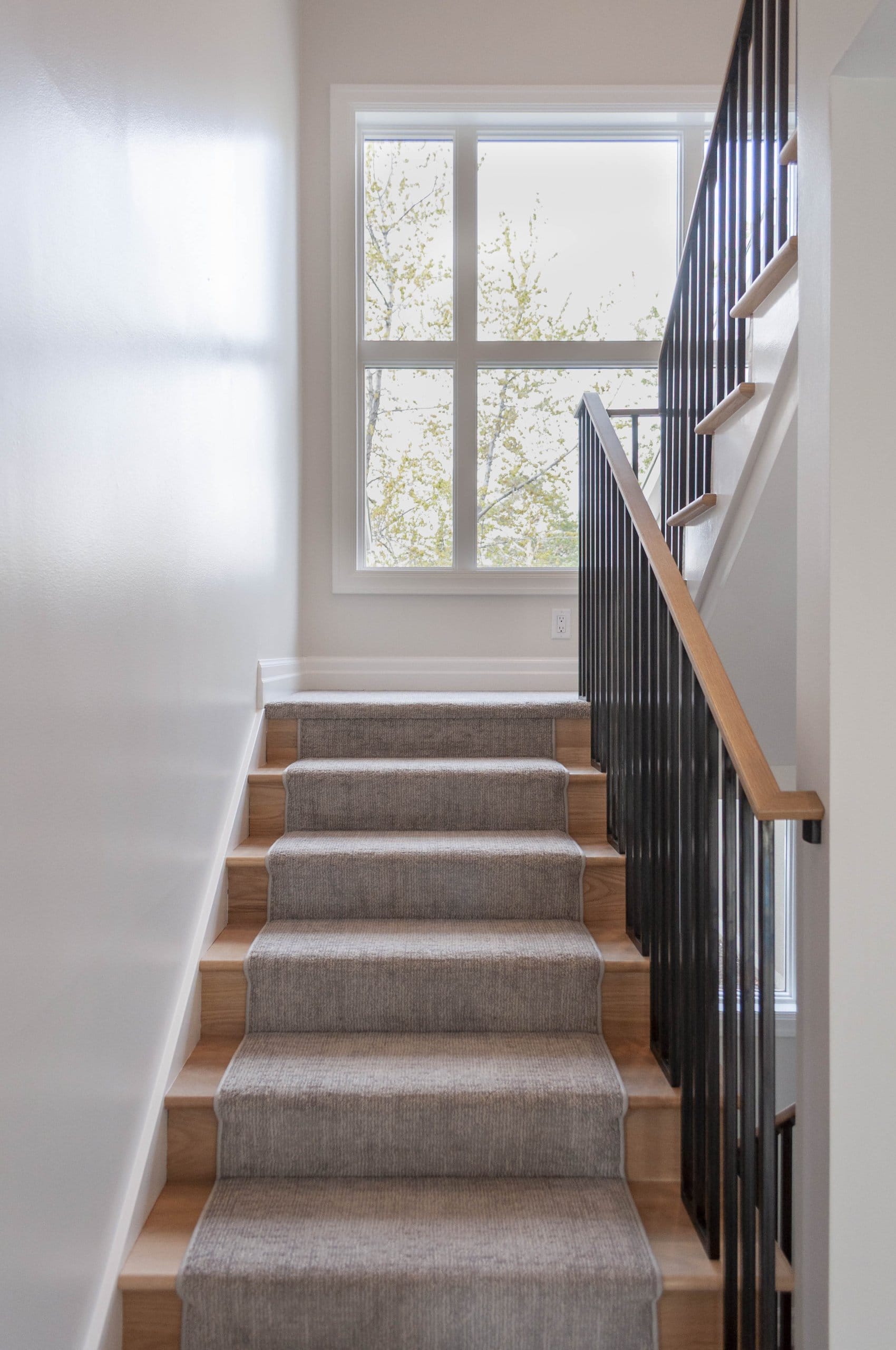 Stairs with a large window at the landing.
