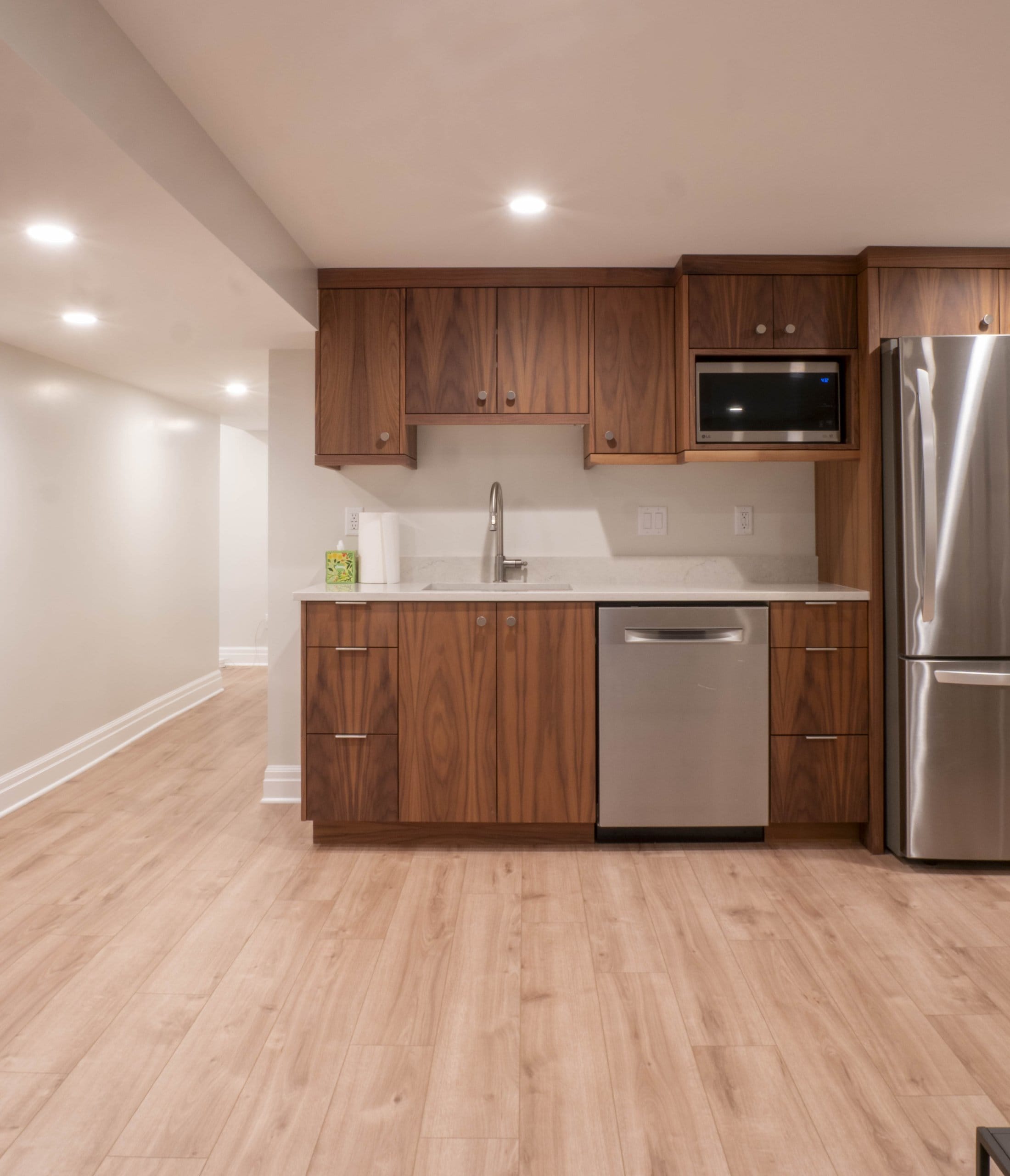 Small kitchen with sink, dishwasher, and fridge.